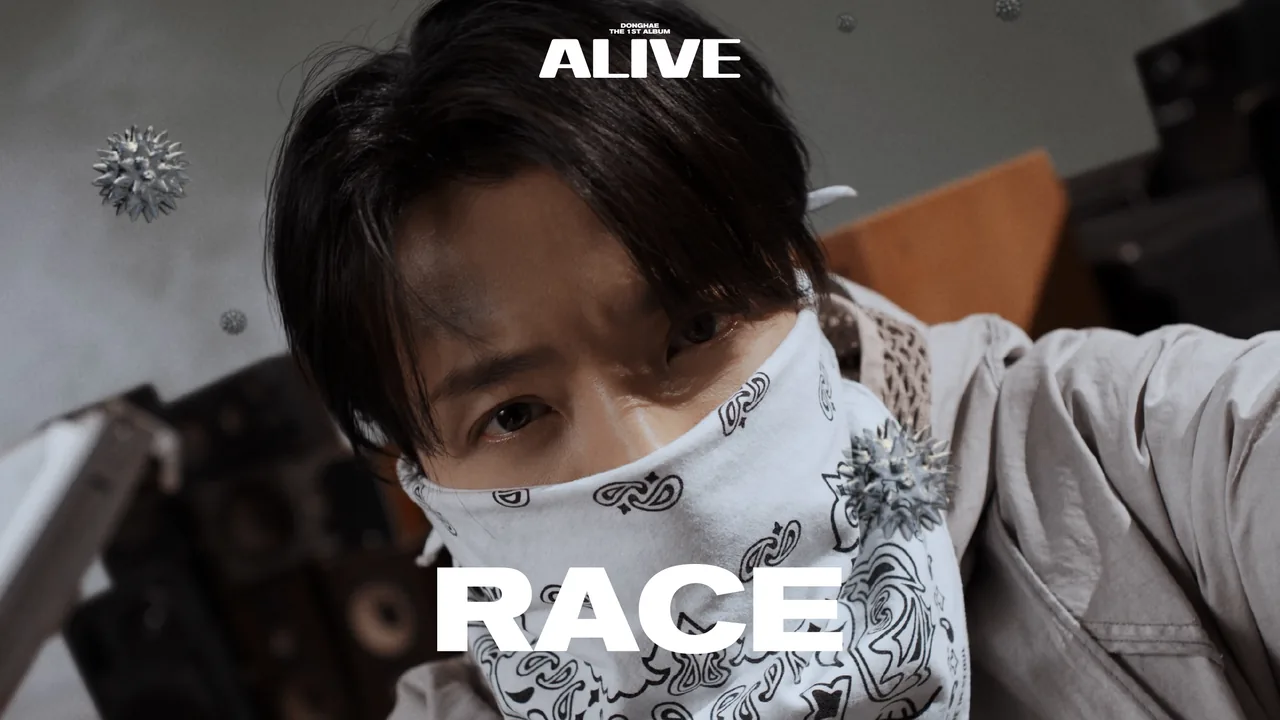 Still from the Race music video — DONGHAE in a bandana mask under the album's ALIVE wordmark, the RACE title across the frame